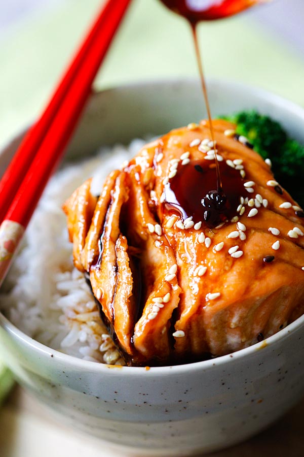 Versez la sauce teriyaki sur le dessus du saumon pour faire un bol de riz teriyaki au saumon.